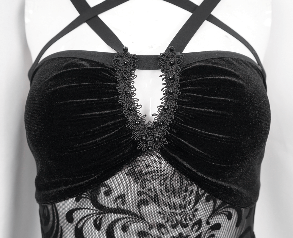 Close-up of a women's vintage black gothic dress featuring strappy design and intricate lace detail.