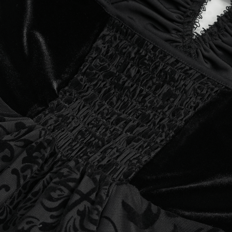 Close-up of black vintage gothic dress fabric, showcasing intricate smocked detailing and luxurious texture.