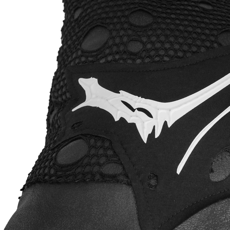 Close-up of black shoe with mesh detail and striking white bone graphic design, perfect for gothic-inspired fashion.