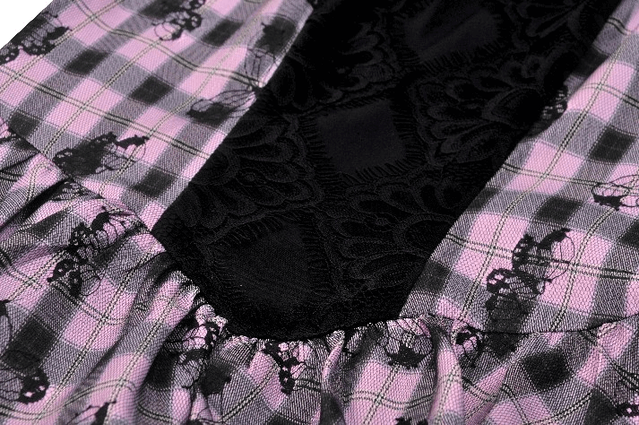 Close-up of gothic plaid dress showcasing black lace and ruffled details, perfect for dark elegance.