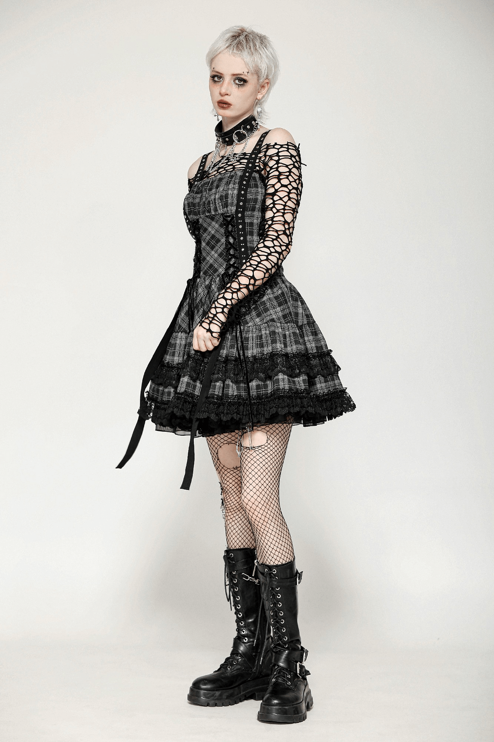 Gothic plaid mini dress with lace trim, harness straps, and fishnet sleeves styled for punk Lolita fashion.