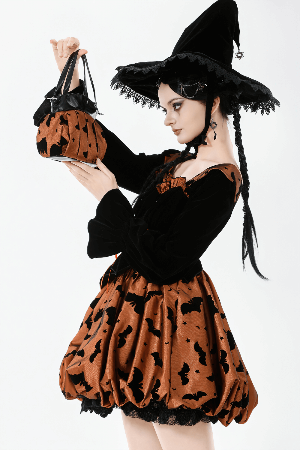 Gothic Pleated Bat and Star Print Handbag with Bat Zipper in a model's hand, paired with a witch costume.