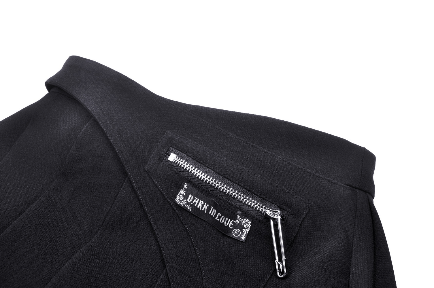 Close-up of gothic mini skirt with side zipper detail and logo, showcasing edgy pleated design.