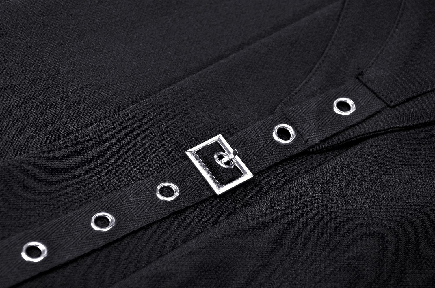 Close-up of silver buckle and eyelet strap on a black Gothic pleated mini skirt, showcasing edgy design details.