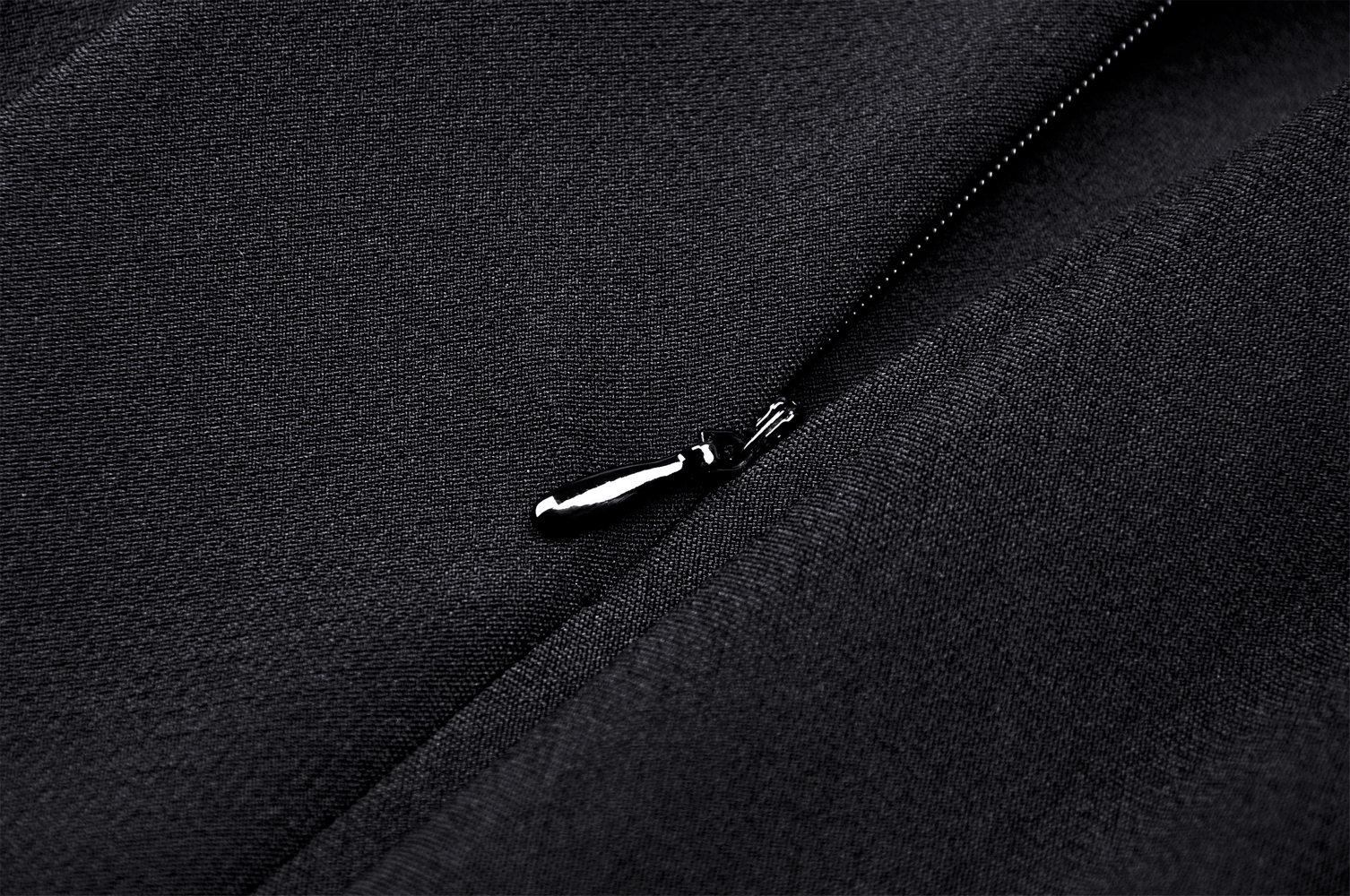 Close-up of the side zipper detail on a gothic pleated mini skirt, showcasing its sleek design and quality craftsmanship.