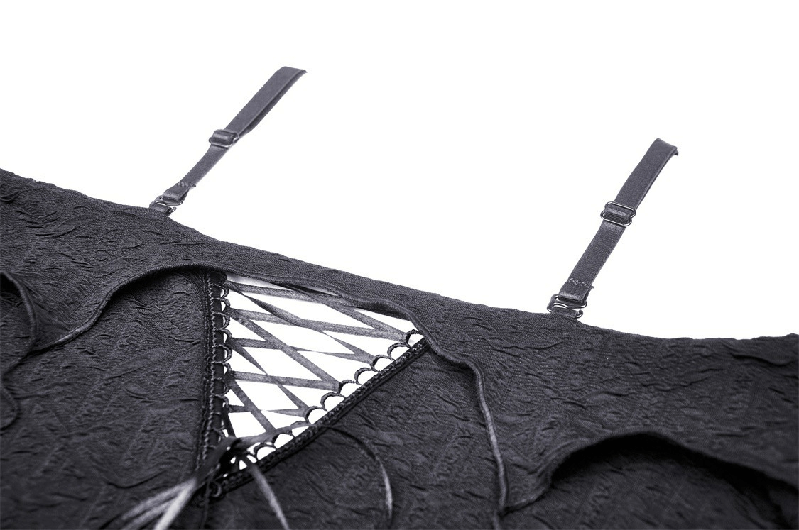 Close-up of gothic off-shoulder crop top with ruffle trim and dramatic lace-up detail.