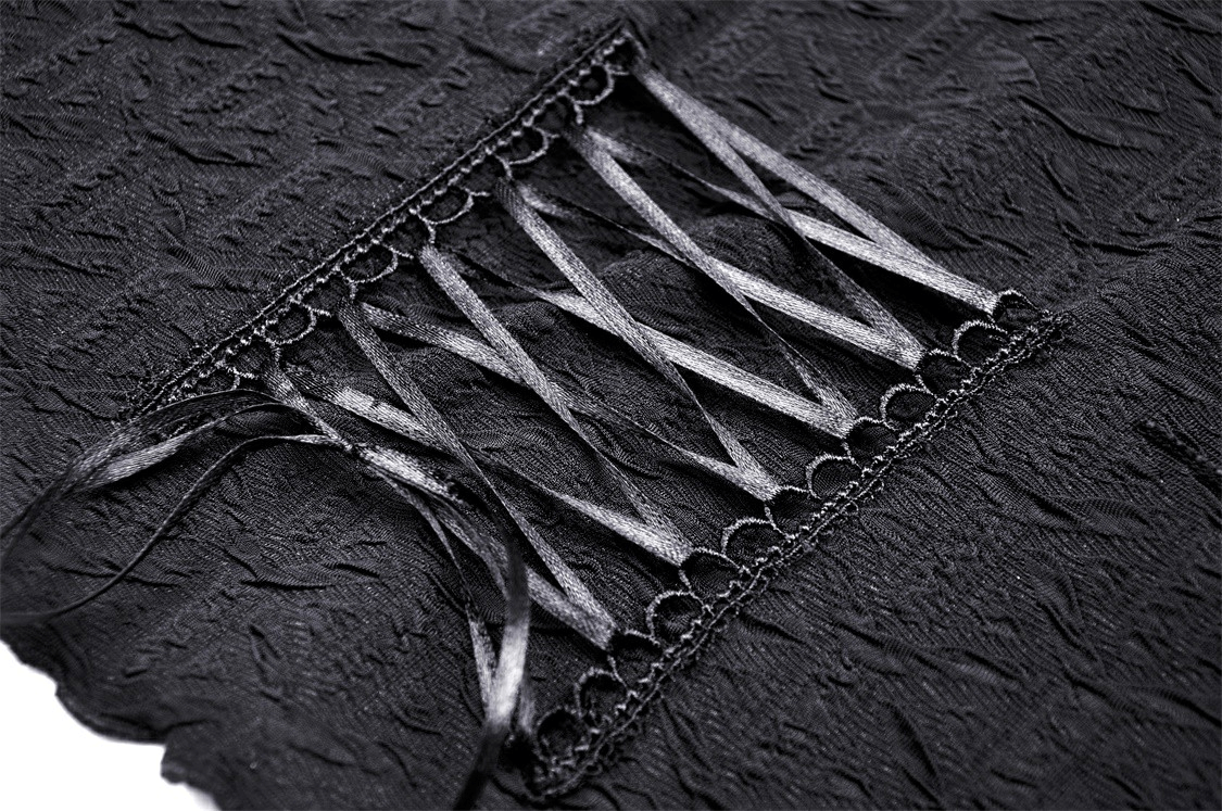 Close-up of a black gothic top featuring dramatic pleated fabric and stylish cutout with ribbon details.