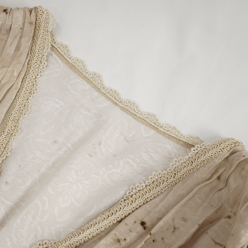 Close-up of the delicate lace trim and textured fabric of a gothic puff sleeve dress, showcasing intricate detailing.