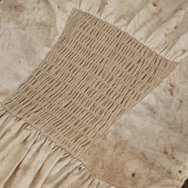 Close-up of the shirred back detail on a gothic-style dress, showcasing its elegant texture and design.