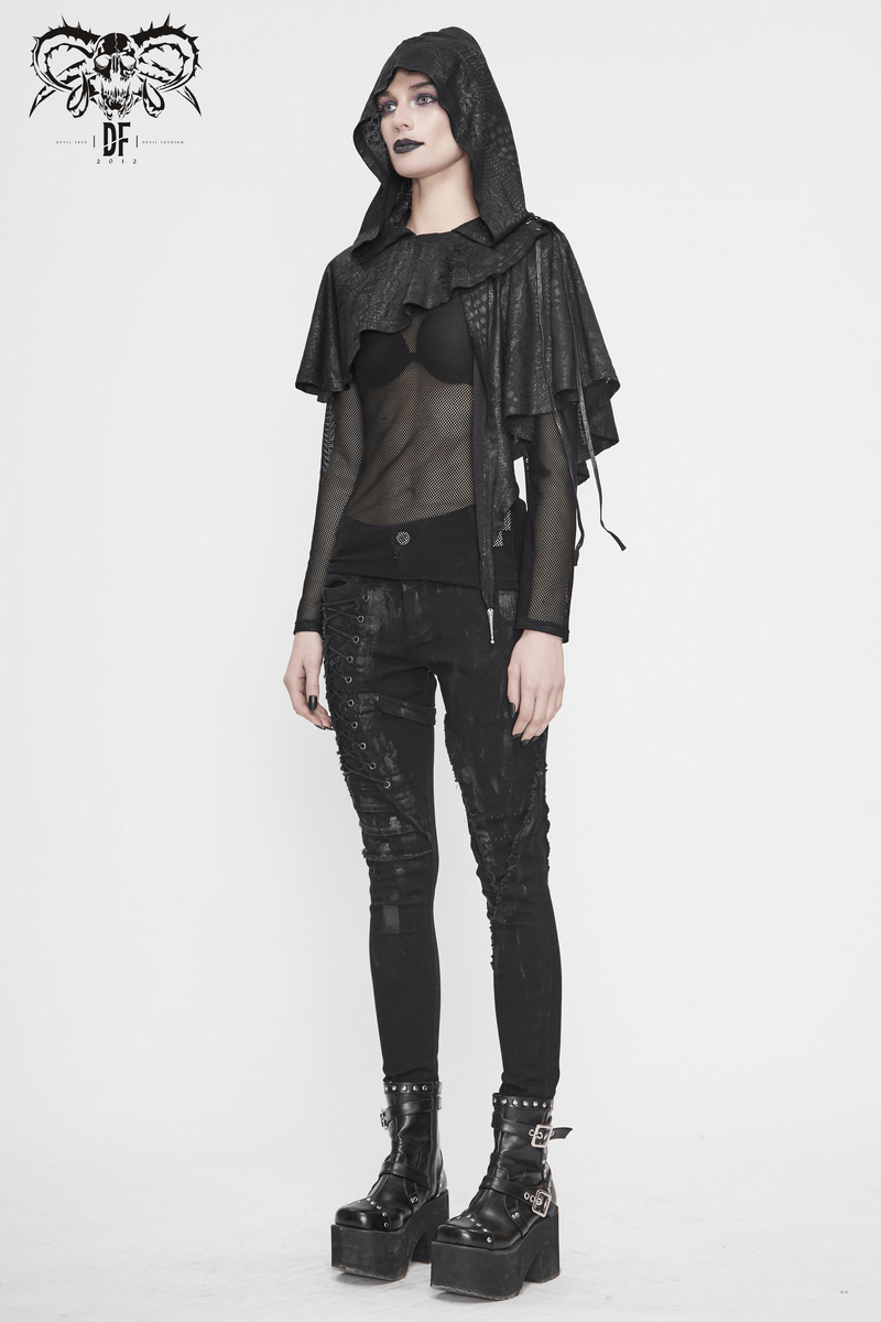 Gothic punk women's black asymmetrical hooded cape with lace-up details, stylishly worn over sheer top and fitted pants.
