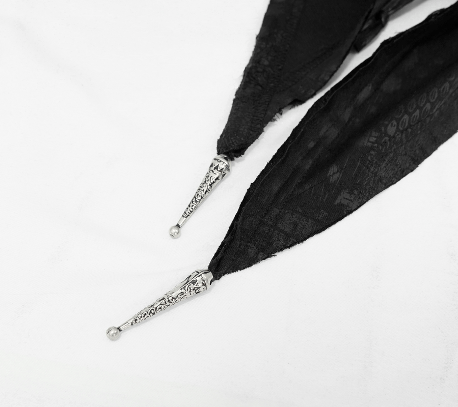 Close-up of lace-up design on a black gothic hooded cape with silver embellishments.