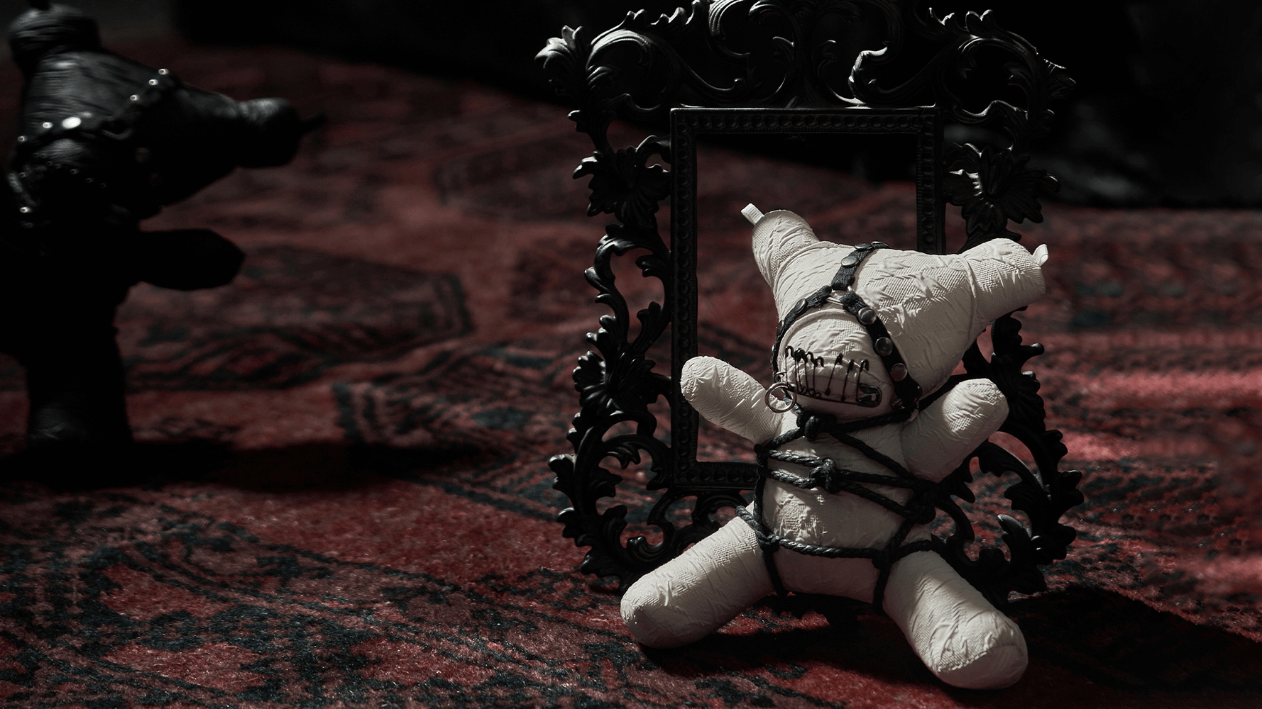 Edgy Gothic bear plush wrapped in chains, styled against a dark background with ornate frame and rich textures.