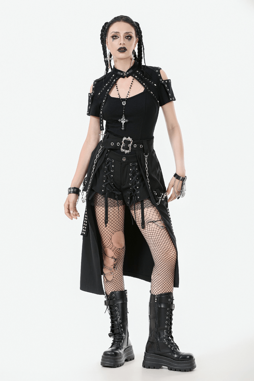 Gothic punk fashion model in a black A-line skirt with chains and buckle, styled with fishnet stockings and platform boots.
