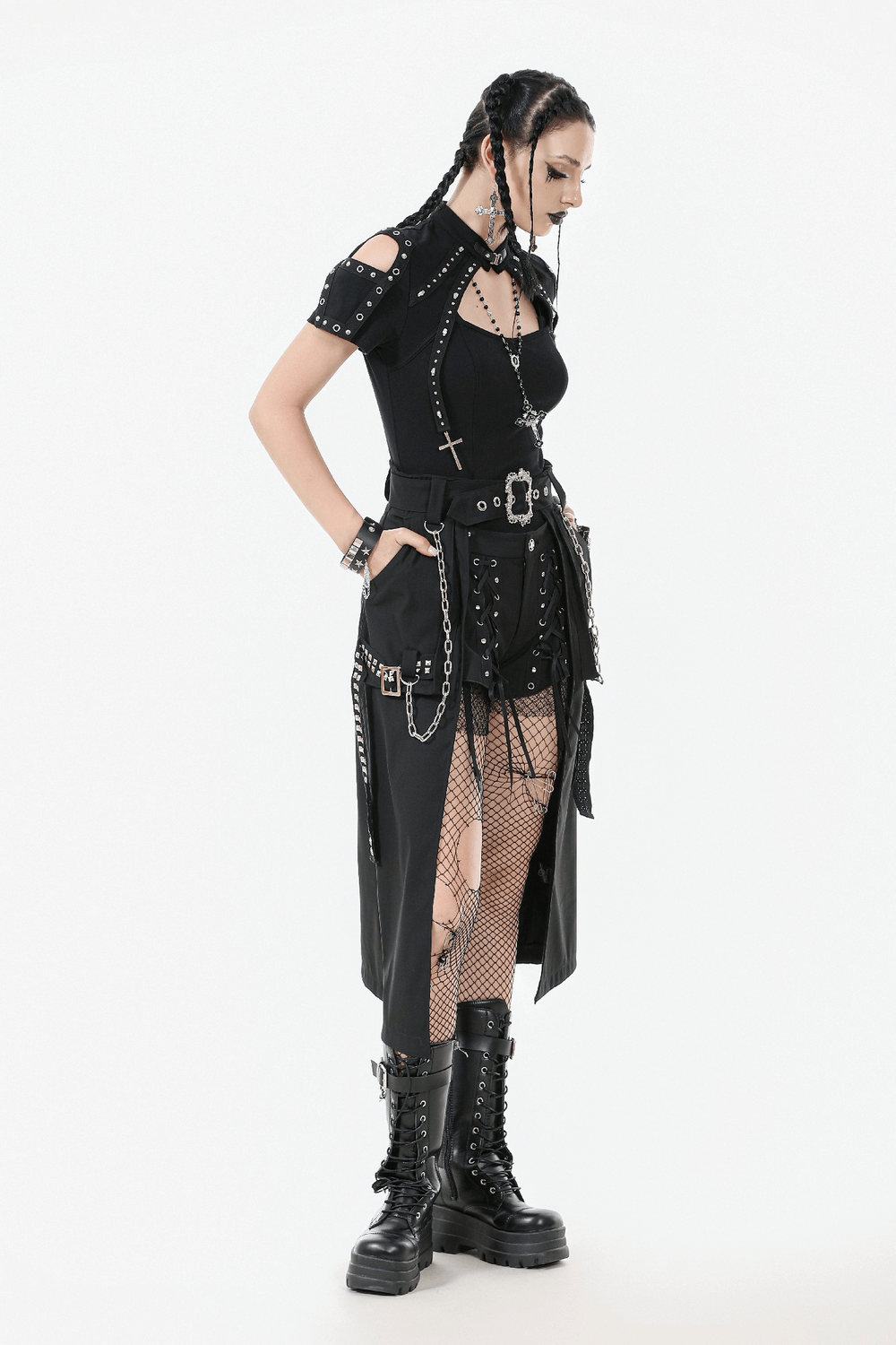 Gothic punk model in black belted skirt with chains, showcasing edgy streetwear style and bold accessories.