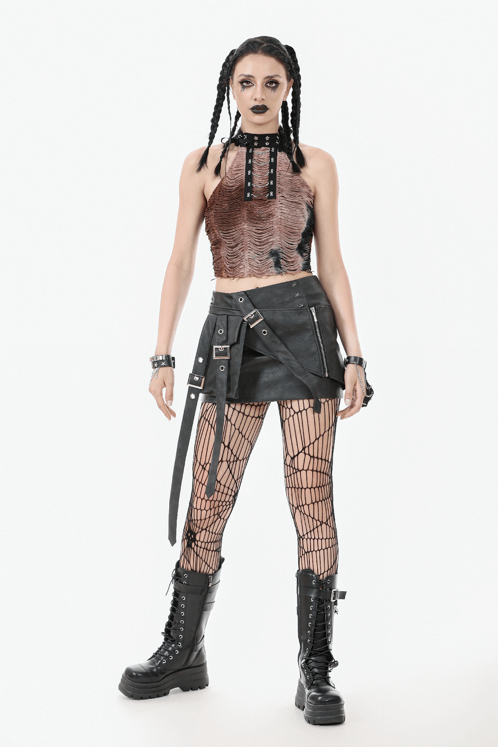 Gothic punk style model in faux leather mini skirt, fishnet tights, and combat boots for edgy outfit inspiration.