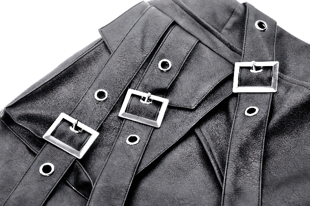 Close-up of gothic punk black faux leather mini skirt with stylish buckle straps and silver accents.