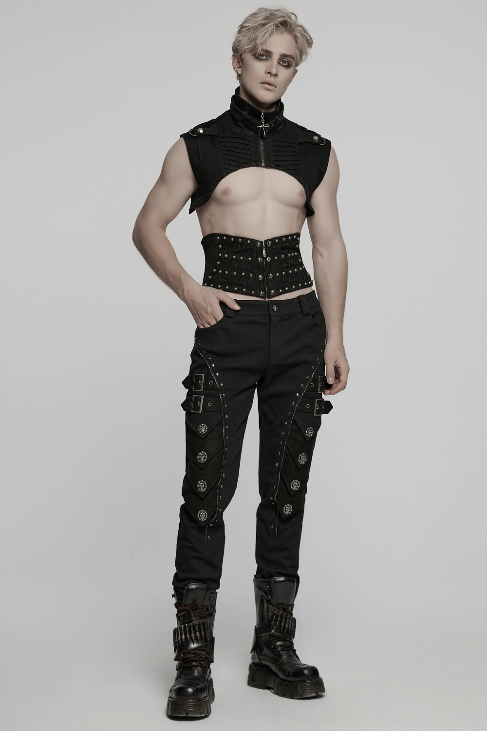 Gothic punk model in black high collar denim cape and studded pants, showcasing edgy streetwear style.