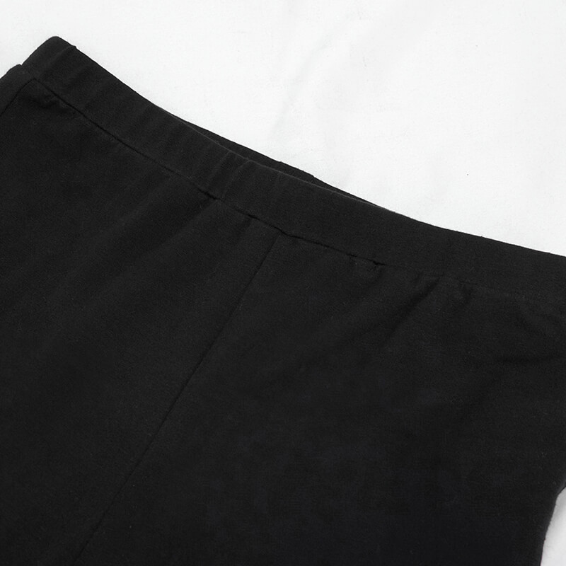 Close-up of the waistband of women's gothic punk black leggings with stretchy fabric for comfort.