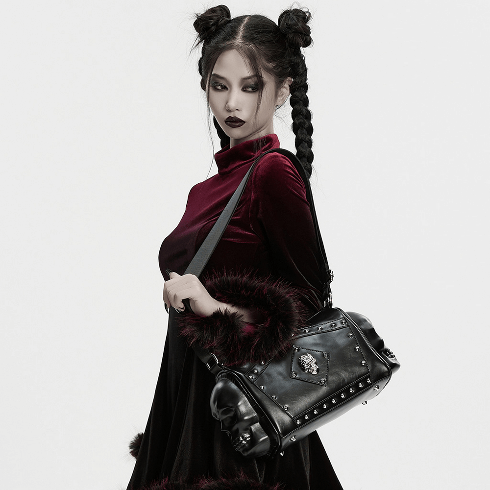 Model showcasing a Gothic Punk Coffin Skull Shoulder Bag with rivets, styled in dark fashion.