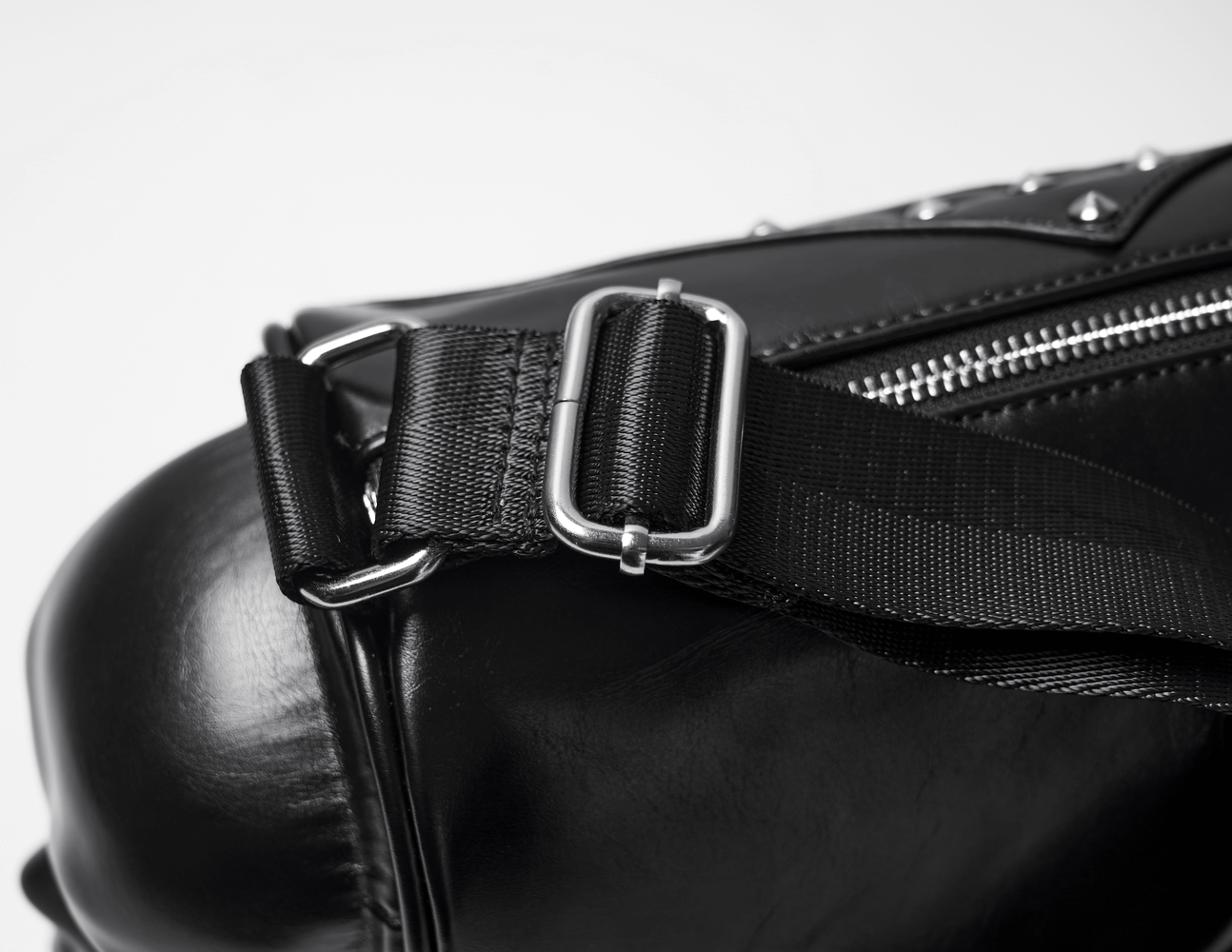Close-up of the adjustable strap and buckle on a gothic punk coffin skull shoulder bag.