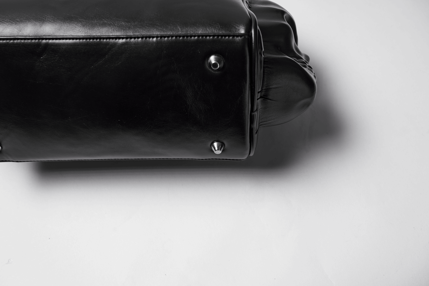 Close-up of Gothic Punk Coffin Skull Shoulder Bag showcasing its eco-friendly leather and metal rivets.