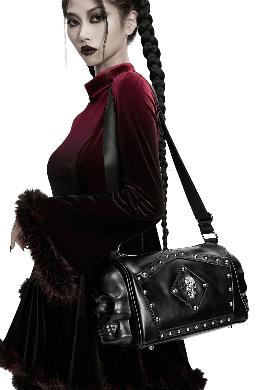Gothic punk coffin skull shoulder bag with rivets, worn by model in dark velvet dress, showcasing bold design.