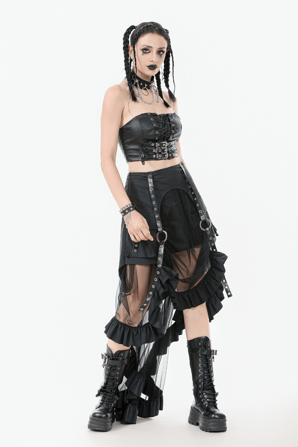 Gothic punk model in faux leather corset top, layered skirt, and combat boots, showcasing edgy alternative fashion.