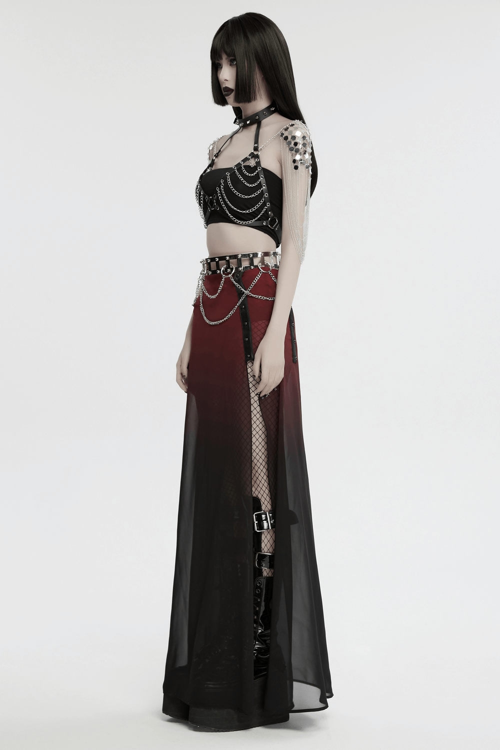 Gothic punk halter harness with chains and spiked neck, styled with a sheer black skirt, featuring bold chest and diamond shoulder chains.