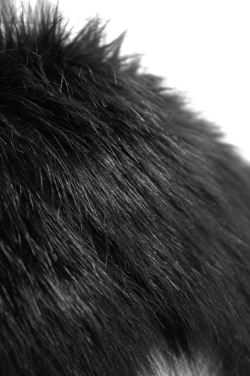 Close-up of soft black fur texture, showcasing the luxurious feel and detail for a gothic punk coat.
