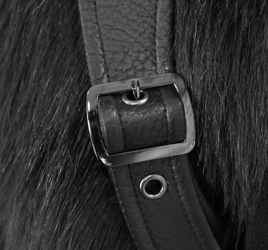 Close-up of a leather strap with a silver buckle and fur, showcasing quality craftsmanship and detail.