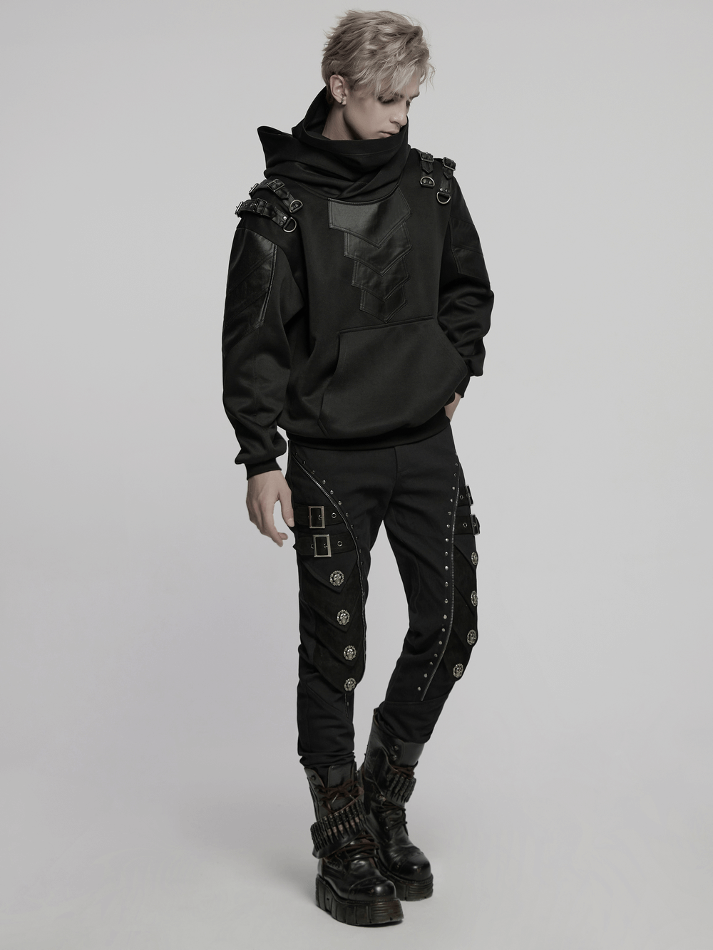 Gothic punk hooded sweatshirt with armor elements and decorative loops, styled with edgy black pants and boots.
