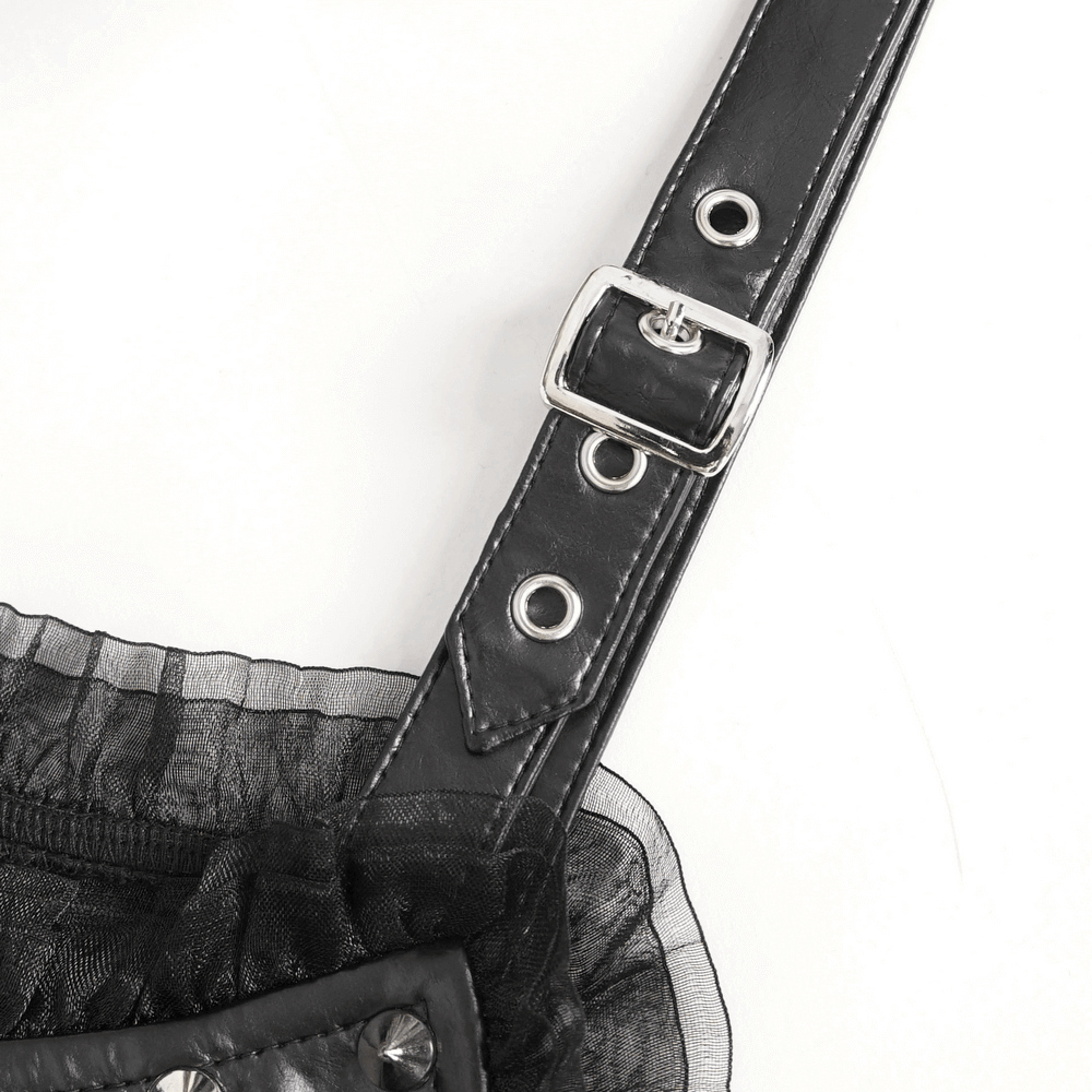 Close-up of the adjustable strap and buckle detail of a gothic black ripped dress.