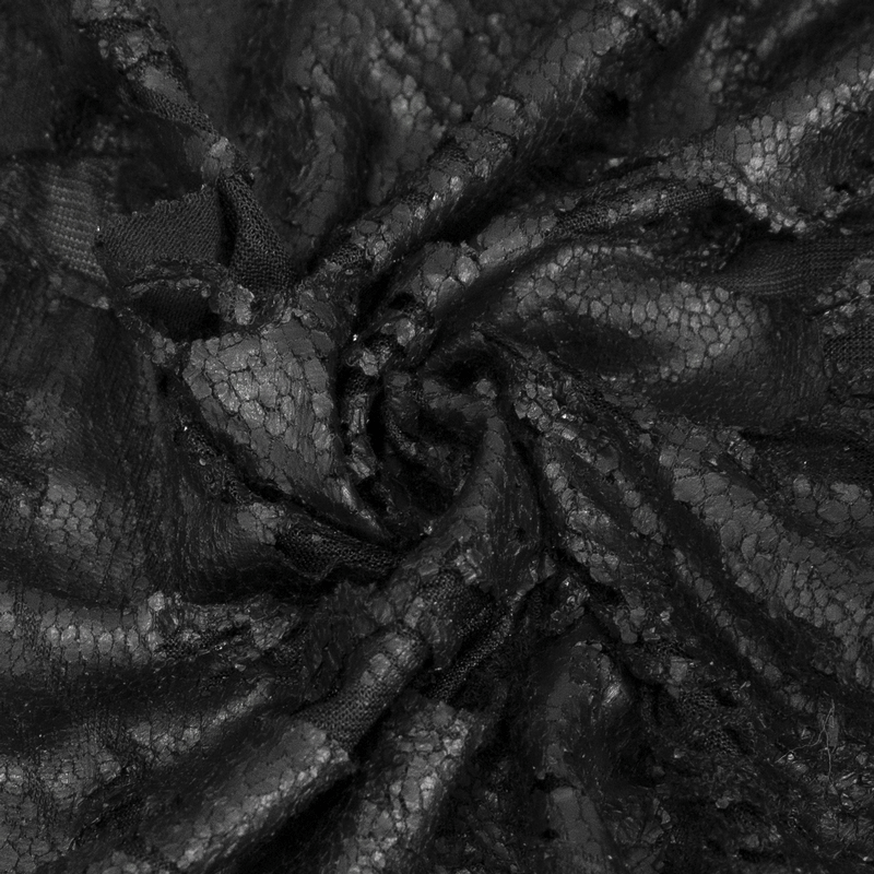 Close-up of textured black lace fabric, showcasing intricate patterns for gothic fashion.