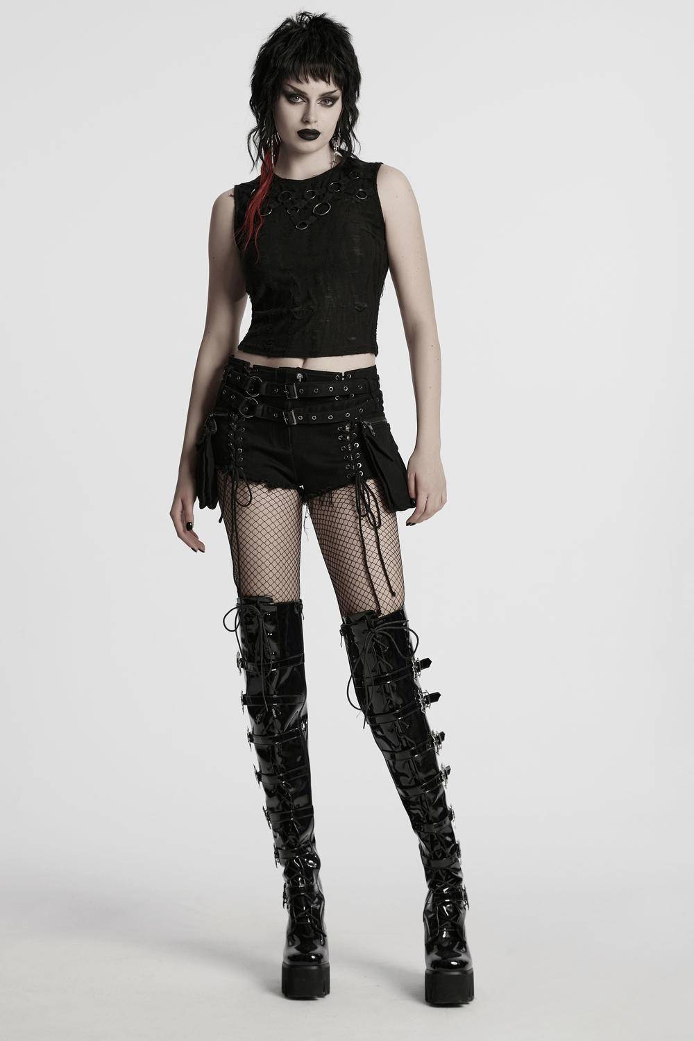 Model in gothic punk black denim lace-up shorts with double belt, fishnet tights, and edgy knee-high boots.