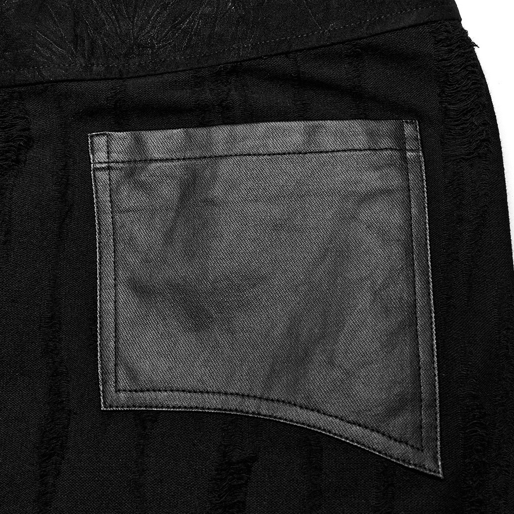 Close-up of a black textured pocket on a gothic punk layered skirt with metallic accents.
