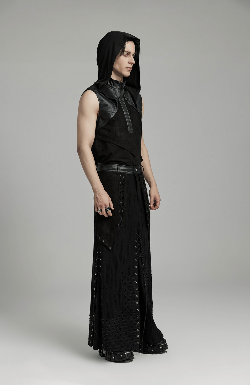 Edgy Gothic punk layered skirt with metallic details on a model, showcasing rebellious fashion and intricate design.