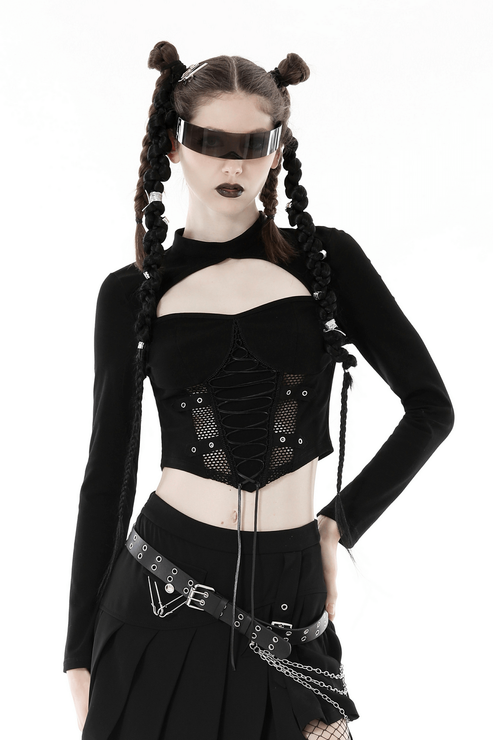 Edgy black mesh crop top with lace-up front and long sleeves, styled by a model in punk fashion.
