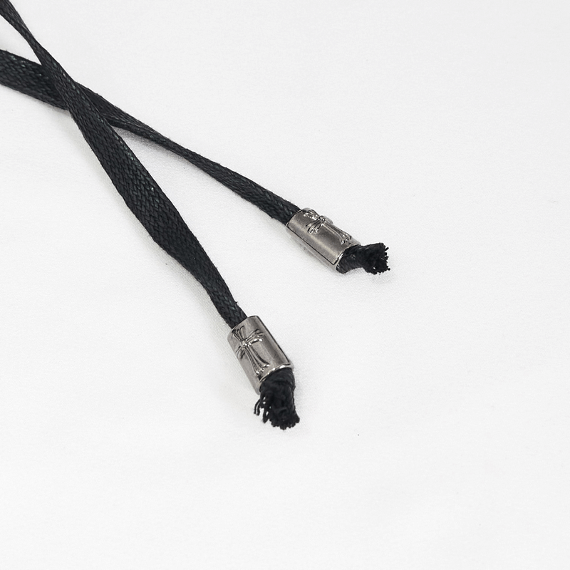 Close-up of black lace-up cords with silver metal tips, perfect for gothic-style fashion or men's black coats.