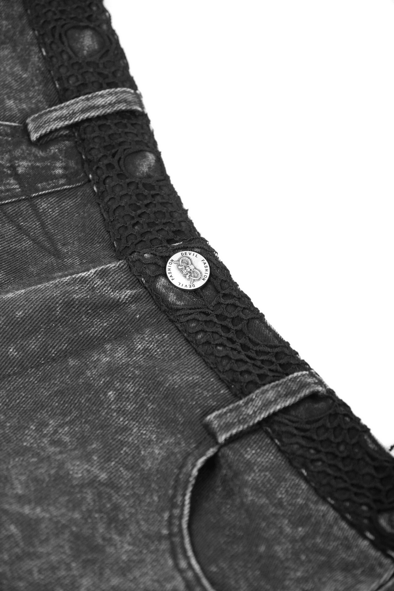 Close-up of black denim shorts featuring decorative rivets and textured waistband, ideal for a punk style look.