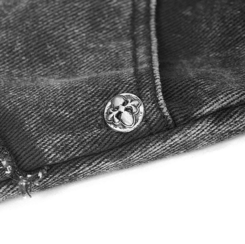 Close-up of silver rivet on black denim shorts, showcasing punk style and quality craftsmanship.