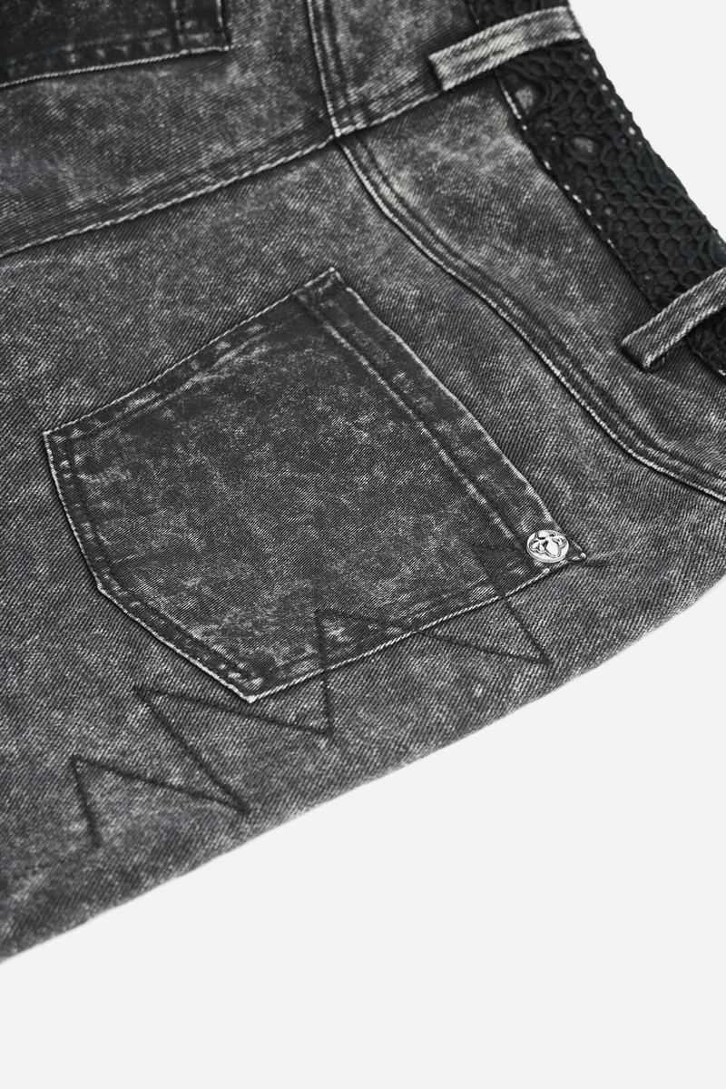 Close-up of men's gothic punk black denim shorts featuring a back pocket and decorative rivets.
