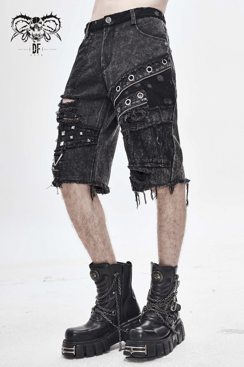 Men's black denim gothic punk ripped shorts with decorative zippers and silver rivets, styled with chunky boots.