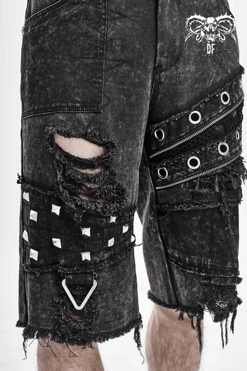 Men's black denim shorts with ripped detail, silver rivets, and decorative zippers, showcasing edgy punk style.