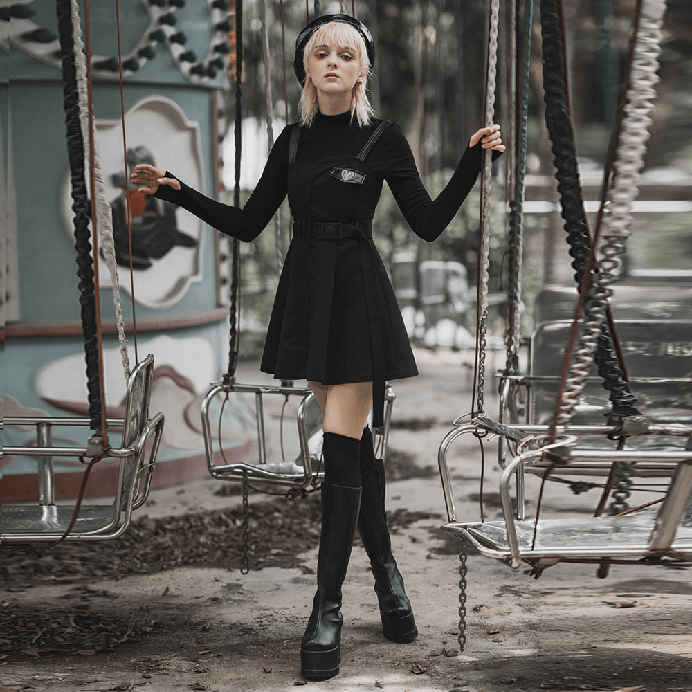 Gothic punk sleeveless dress with belt, featuring a unique silhouette and stylish knee-high boots.
