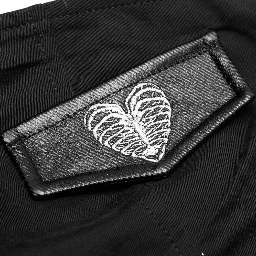 Close-up of the leather patch on the Gothic Punk dress featuring a heart-shaped embroidered design.