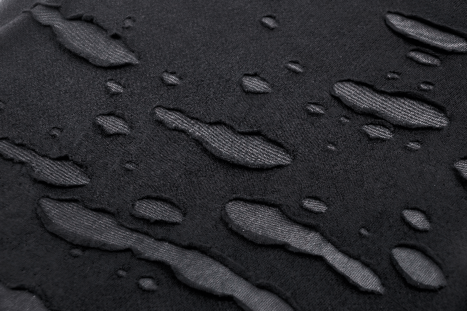 Close-up of edgy black fabric with artistic ripped details showcasing texture and style.
