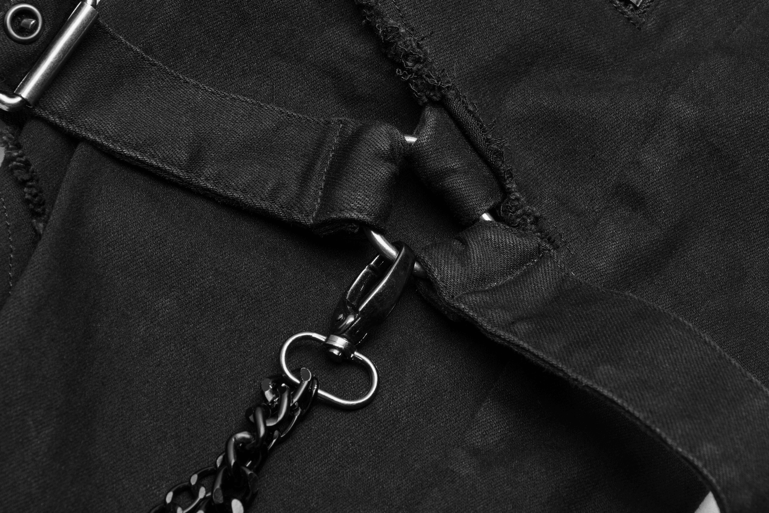 Close-up of Gothic Punk cargo pants showcasing black fabric and metal chain accents.
