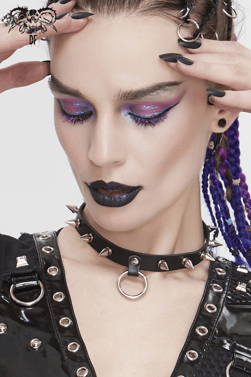Gothic punk style unisex black leather choker with O-ring and spikes, worn by model with bold makeup.