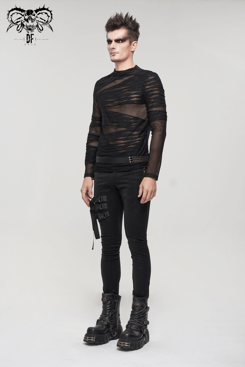 Stylish male model in a gothic punk transparent black top with irregular stripes, paired with skinny black pants and bold boots.