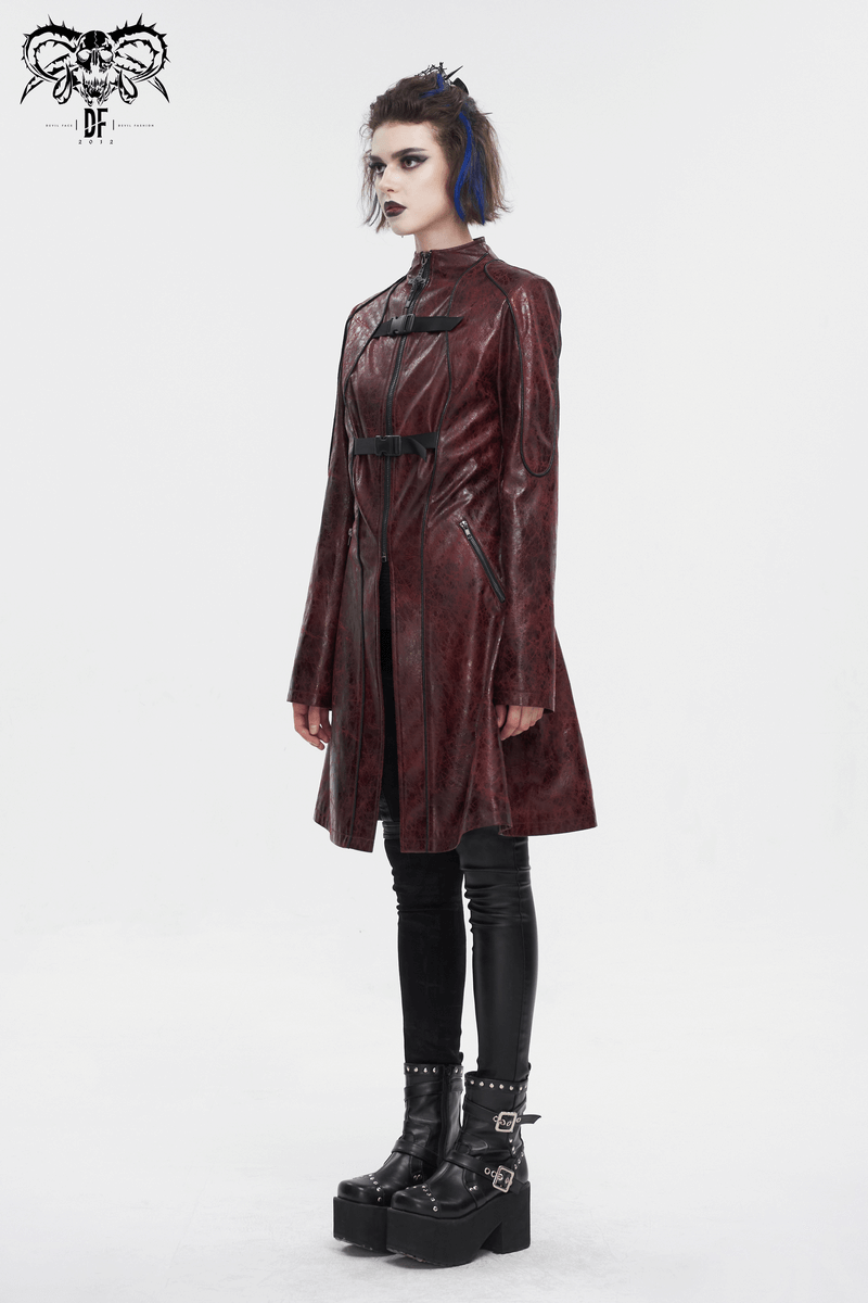 Gothic punk woman in a red faux leather mid-length coat with double buckles and platform boots.
